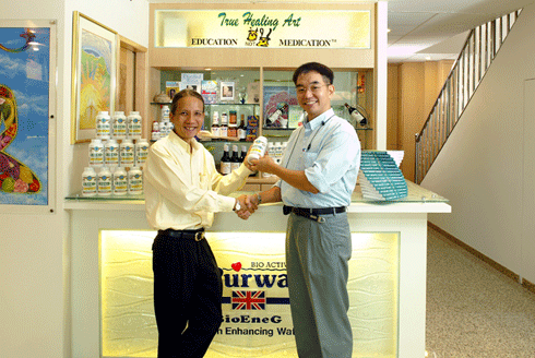 Picture of our founder and a customer shaking hands in front of our sales counter.